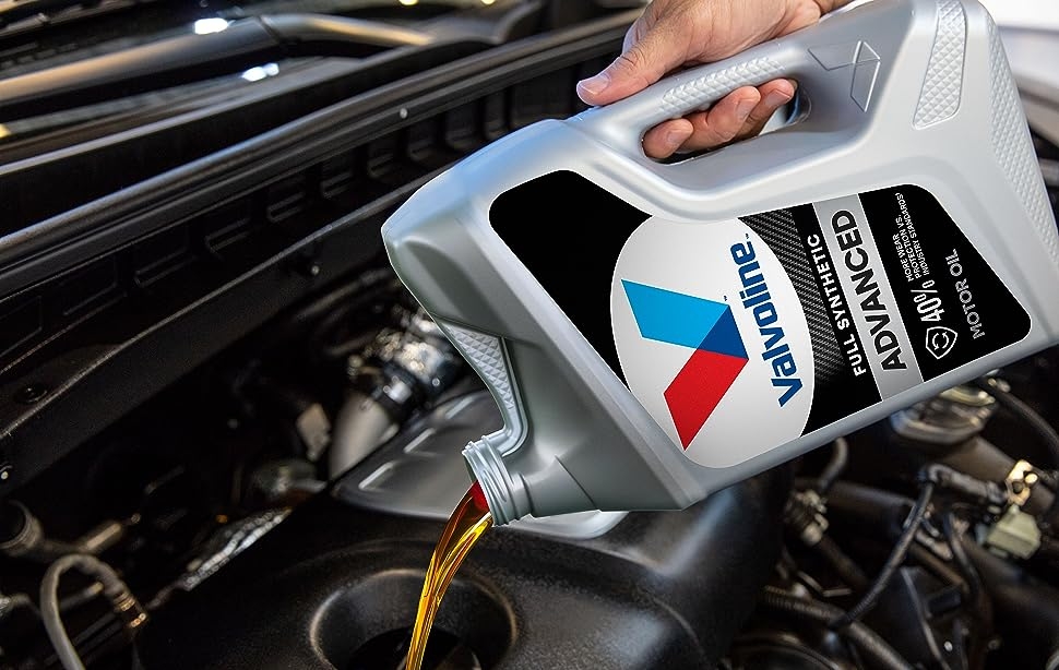 valvoline full synthetic motor oil being poured into an engine